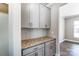 Additional kitchen counter space with gray cabinets and granite top at 822 N Rocky River Rd, Monroe, NC 28110