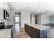 Modern kitchen with granite countertops, stainless steel appliances, and an island at 822 N Rocky River Rd, Monroe, NC 28110