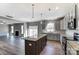 Modern kitchen with granite island, stainless steel appliances, and hardwood floors at 822 N Rocky River Rd, Monroe, NC 28110