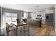 Modern kitchen with island, stainless steel appliances, and granite countertops at 822 N Rocky River Rd, Monroe, NC 28110
