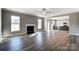 Open concept living room with hardwood floors, fireplace and kitchen view at 822 N Rocky River Rd, Monroe, NC 28110