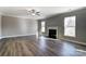 Bright living room with hardwood floors, fireplace and ceiling fan at 822 N Rocky River Rd, Monroe, NC 28110