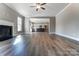 Open concept living room with hardwood floors, fireplace and kitchen view at 822 N Rocky River Rd, Monroe, NC 28110