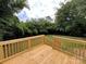 Deck overlooks a large backyard with lush green grass and trees at 647 Reeves Ct, Charlotte, NC 28208