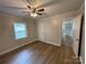 Bedroom with ceiling fan, neutral walls and wood-look flooring at 647 Reeves Ct, Charlotte, NC 28208