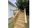 Wooden deck with stairs leading to the backyard at 647 Reeves Ct, Charlotte, NC 28208