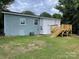 Newly painted light blue house exterior with a white addition and a wooden deck at 647 Reeves Ct, Charlotte, NC 28208