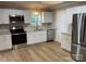 Updated kitchen with stainless steel appliances and granite countertops at 647 Reeves Ct, Charlotte, NC 28208
