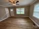 Living room with hardwood floors, neutral walls, and a ceiling fan at 647 Reeves Ct, Charlotte, NC 28208