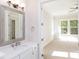 Bright bathroom with vanity, mirror, and access to bedroom at 1025 Patterson Farm Rd, Mooresville, NC 28115