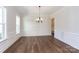 Formal dining room with hardwood floors, wainscoting, and chandelier at 1025 Patterson Farm Rd, Mooresville, NC 28115