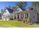 Two-story house with a front porch, two-car garage, and nicely landscaped yard at 1025 Patterson Farm Rd, Mooresville, NC 28115