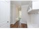 Hallway with hardwood floors and access to other rooms at 1025 Patterson Farm Rd, Mooresville, NC 28115