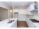 White kitchen with corner cabinets, marble island, and stainless steel appliances at 1025 Patterson Farm Rd, Mooresville, NC 28115