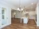 Open kitchen with island, hardwood floors, and breakfast area at 1025 Patterson Farm Rd, Mooresville, NC 28115