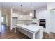 Modern kitchen with white cabinets, large island, and stainless steel appliances at 1025 Patterson Farm Rd, Mooresville, NC 28115
