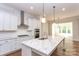 Modern kitchen with white cabinets, marble countertops, and stainless steel appliances at 1025 Patterson Farm Rd, Mooresville, NC 28115