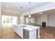 Open concept kitchen with island, hardwood floors, and views into Gathering room at 1025 Patterson Farm Rd, Mooresville, NC 28115