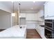 Bright kitchen with white cabinets, marble countertops, and stainless steel appliances at 1025 Patterson Farm Rd, Mooresville, NC 28115