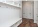 Mudroom with built-in bench, cubbies, and coat hooks at 1025 Patterson Farm Rd, Mooresville, NC 28115