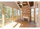 Screened porch with stone fireplace and ceiling fan, great for relaxing at 1025 Patterson Farm Rd, Mooresville, NC 28115