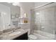 Clean bathroom with granite countertop, a bathtub, and a glass shower at 16015 Vale Ridge Dr # 133, Charlotte, NC 28278