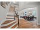 Elegant two-story entry with hardwood floors, formal dining area, and a curved staircase at 16015 Vale Ridge Dr # 133, Charlotte, NC 28278