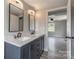 Stylish bathroom featuring a double vanity with marble countertop and matte black fixtures at 55 Shannon Park Cir, Taylorsville, NC 28681