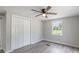 Bedroom featuring hardwood floors, window, and closet with bi-fold doors at 55 Shannon Park Cir, Taylorsville, NC 28681