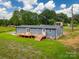 This single-story home features a wooden porch with access to the yard and the back of the house at 55 Shannon Park Cir, Taylorsville, NC 28681