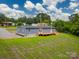 Aerial view of a single-story house with a big yard and a wooden porch at 55 Shannon Park Cir, Taylorsville, NC 28681