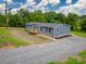 Aerial view of the home shows an expansive yard, gravel driveway, and gray siding at 55 Shannon Park Cir, Taylorsville, NC 28681