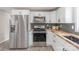 Bright kitchen featuring stainless steel appliances, white cabinetry and beautiful butcher block countertops at 55 Shannon Park Cir, Taylorsville, NC 28681
