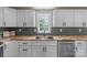 Updated kitchen with white cabinets, stainless steel appliances, and butcher block countertops at 55 Shannon Park Cir, Taylorsville, NC 28681