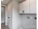 Clean laundry room with white cabinets, and connection boxes at 55 Shannon Park Cir, Taylorsville, NC 28681