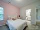 Bedroom with pink walls, a bed, and an ensuite bathroom at 209 Meyers Ridge Rd, Cramerton, NC 28032