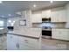 Modern kitchen with white cabinets, stainless steel appliances and breakfast bar at 209 Meyers Ridge Rd, Cramerton, NC 28032