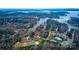 Expansive aerial view of the property showcasing lush greenery, a tranquil lake, and neighborhood amenities at 301 Agnew Rd, Mooresville, NC 28117