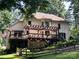 Large back deck with wooden pergola overlooking a scenic backyard and peaceful property at 301 Agnew Rd, Mooresville, NC 28117