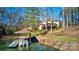 Picturesque backyard with lake access, a boat dock, and a charming covered seating area at 301 Agnew Rd, Mooresville, NC 28117