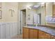 Bright bathroom with granite countertops, a large mirror, and a skylight for natural lighting at 301 Agnew Rd, Mooresville, NC 28117