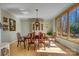 Dining room featuring hardwood floors, an elegant dining set, and a large window showcasing a beautiful view at 301 Agnew Rd, Mooresville, NC 28117