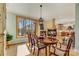 Bright dining room with hardwood floors, a fireplace, a large window with a view, and an elegant dining set at 301 Agnew Rd, Mooresville, NC 28117