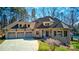 Charming stone home with a three-car garage, well manicured lawn and mature trees at 301 Agnew Rd, Mooresville, NC 28117