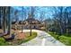 Stunning stone home with a three-car garage, long driveway and lush, green lawn at 301 Agnew Rd, Mooresville, NC 28117