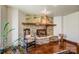 Close-up of a stone fireplace with a wooden mantel, ornate details, and a cozy seating arrangement nearby at 301 Agnew Rd, Mooresville, NC 28117