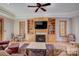 Cozy living room featuring a fireplace, built-in shelving, and hardwood floors at 301 Agnew Rd, Mooresville, NC 28117