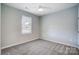 Simple bedroom with grey carpet and window at 1511 28Th Street Se Pl, Hickory, NC 28602