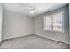 Bright bedroom with grey carpet and large window at 1511 28Th Street Se Pl, Hickory, NC 28602