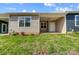 Tan and gray siding home with covered patio and grassy yard at 1511 28Th Street Se Pl, Hickory, NC 28602